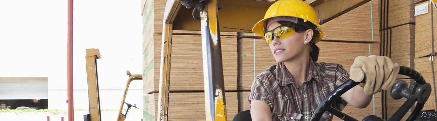 industrial worker driving forklift