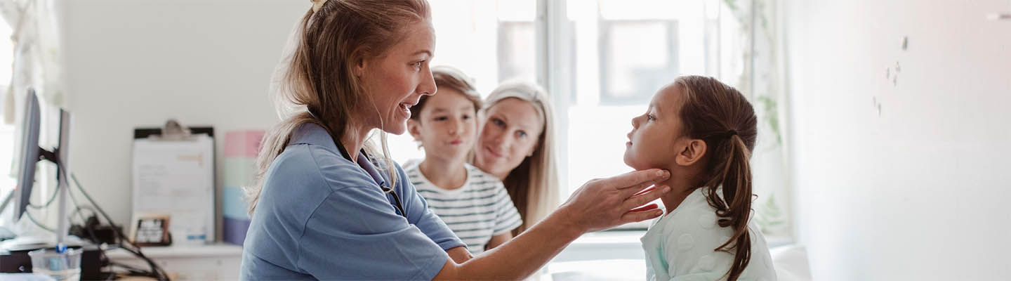 doctor examines girl in medical room