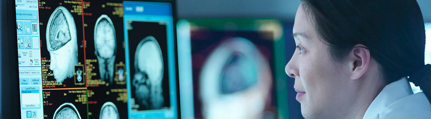 A neurologist reviews a patient's brain scan images.