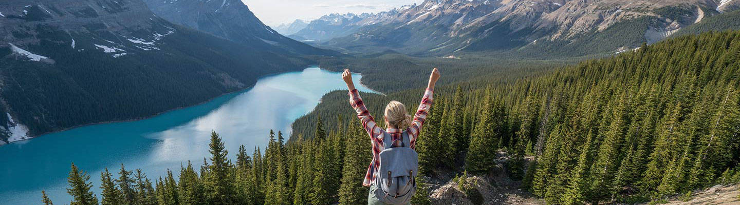 Girl lifting hands while hiking in the mountains