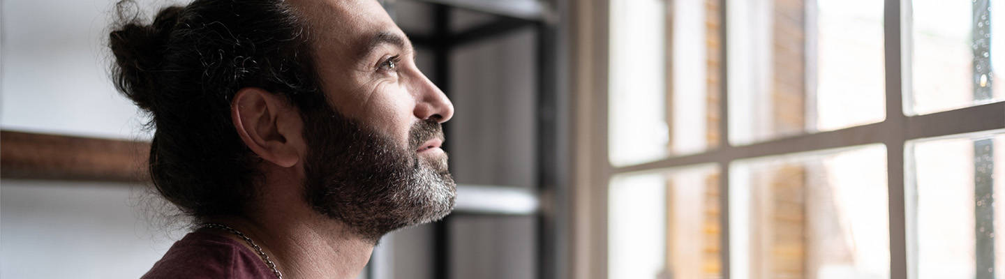 Man looking out window